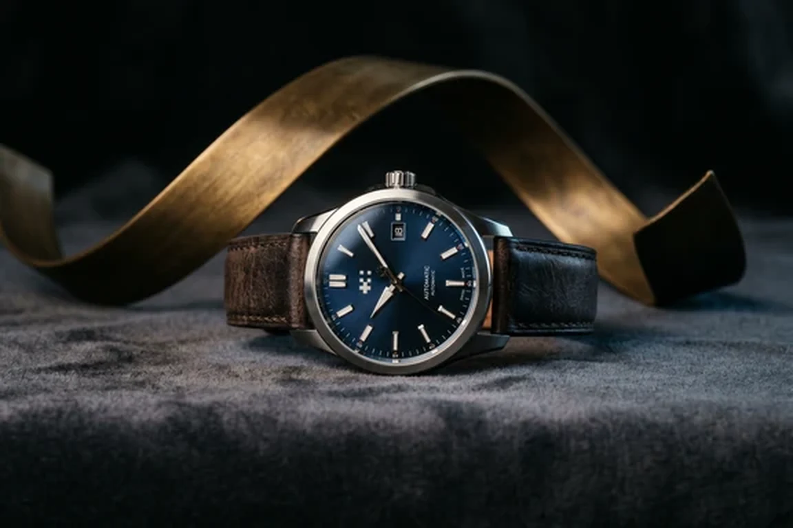 Luxury watch on dark velvet with single dramatic key light